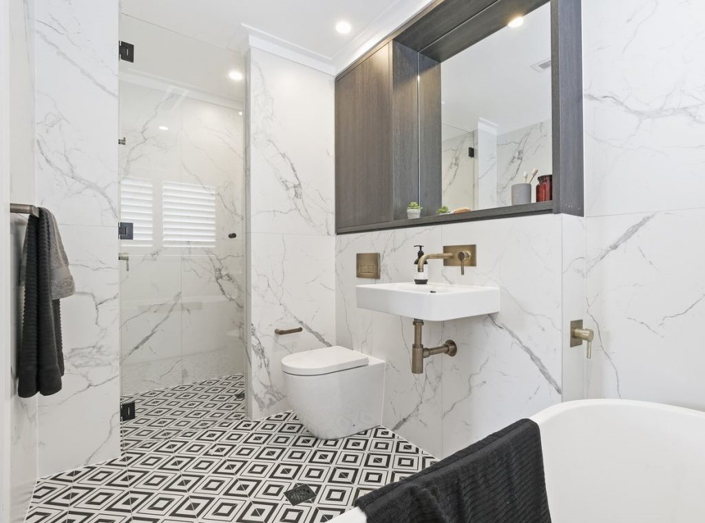 monochromatic theme bathroom with carrara porcelain wall tiles
